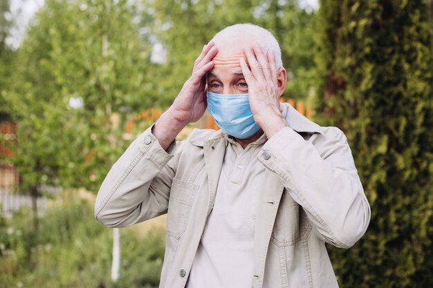 Фото semior мужчина в изумлении в респираторе, чтобы защитить от заражения вирусом гриппа или коронавируса