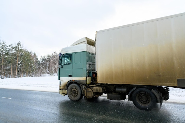 A semitrailer truck semitruck tractor unit and semitrailer to carry freight Cargo transportation in harsh winter conditions on slippery icy and snowy roads