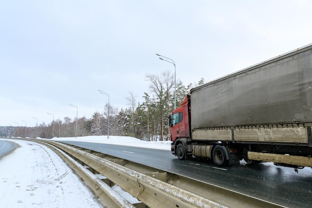 A semitrailer truck semitruck tractor unit and semitrailer to carry freight Cargo transportation in harsh winter conditions on slippery icy and snowy roads