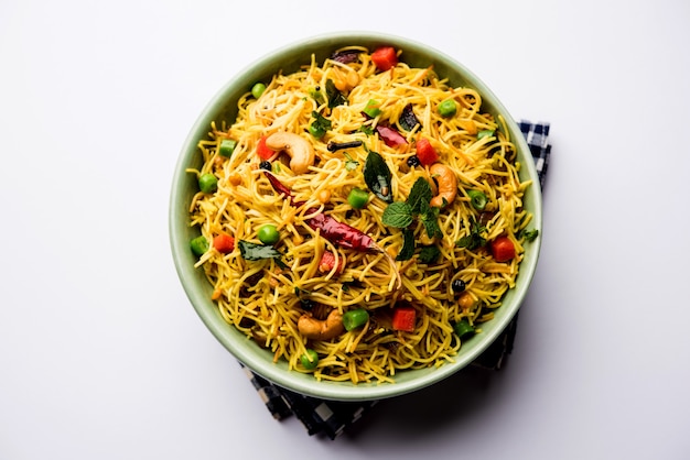 Semiya Upma or Vermicelli Uppuma or uppittu is a popular breakfast menu from south India. served in a bowl. selective focus