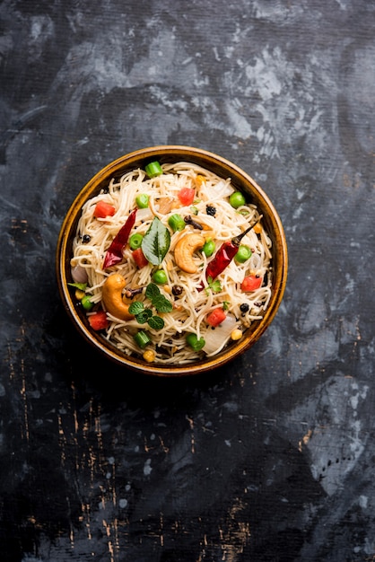 Semiya Upma or Vermicelli Uppuma or uppittu is a popular breakfast menu from south India. served in a bowl. selective focus