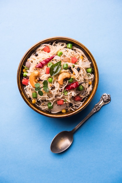 Semiya Upma or Vermicelli Uppuma or uppittu is a popular breakfast menu from south India. served in a bowl. selective focus