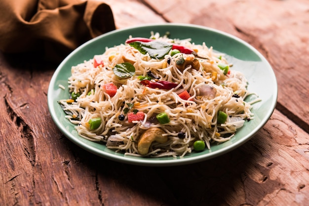 Semiya Upma or Vermicelli Uppuma or uppittu is a popular breakfast menu from south India. served in a bowl. selective focus