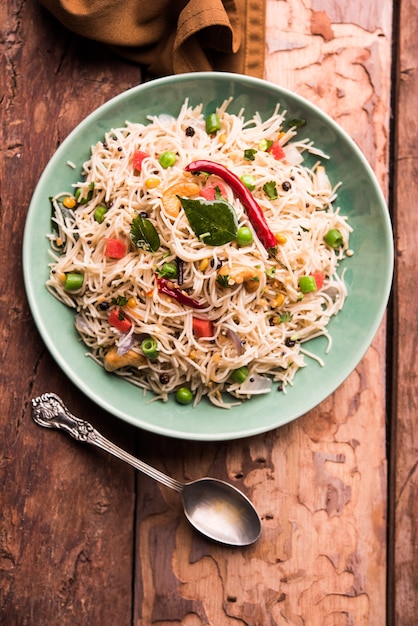 Semiya Upma or Vermicelli Uppuma or uppittu is a popular breakfast menu from south India. served in a bowl. selective focus
