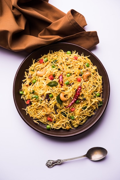 Semiya Upma or Vermicelli Uppuma or uppittu is a popular breakfast menu from south India. served in a bowl. selective focus