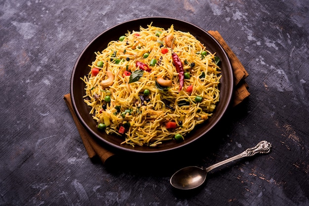 Semiya Upma or Vermicelli Uppuma or uppittu is a popular breakfast menu from south India. served in a bowl. selective focus