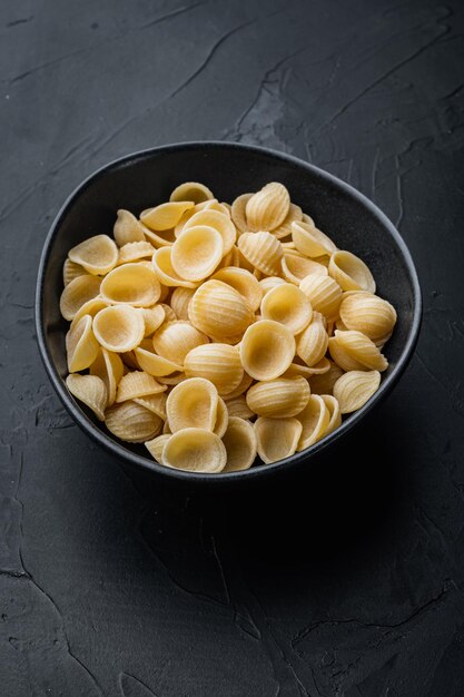 Semolina pasta dried on black background