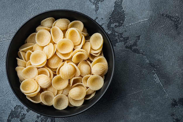 Semolina pasta dried, on gray table, top view