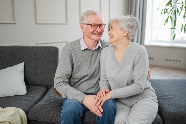 Photo senior adult mature couple hugging at home mid age old husband and wife embracing with tenderness