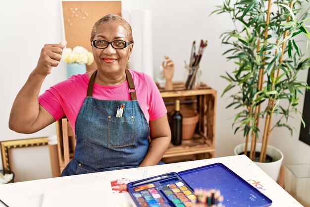 Senior african american woman communicating with deaf language at art studio