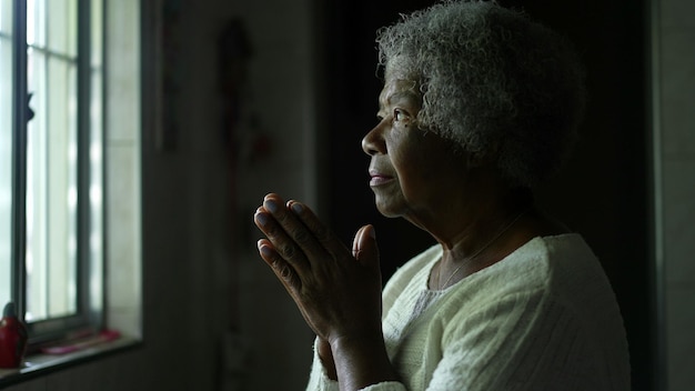 A senior african woman opening eyes with hope and faith