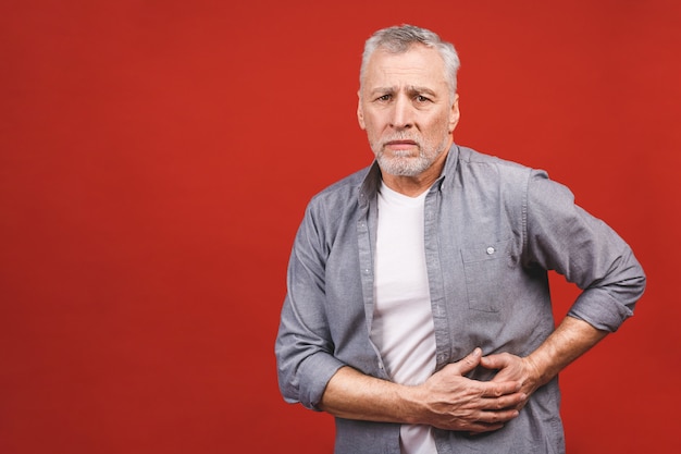 Senior aged man holds the liver. Pain in the abdomen. Cirrhosis of the liver. Closeup. Isolated.