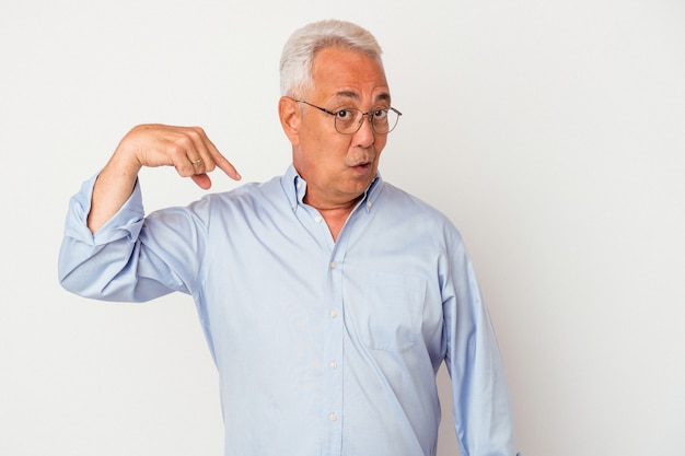 Senior american man isolated on white background person pointing by hand to a shirt copy space, proud and confident