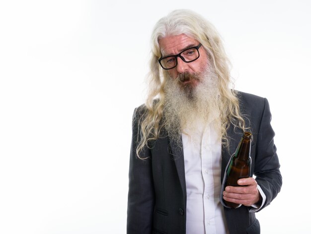 senior bearded businessman holding bottle of beer