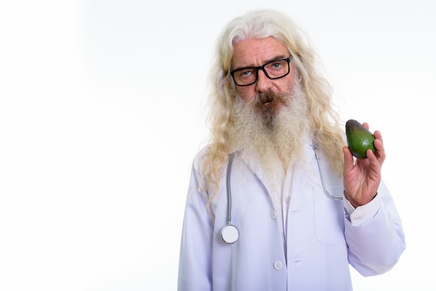 senior bearded man doctor holding avocado