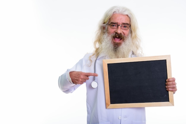 senior bearded man doctor holding blank blackboard