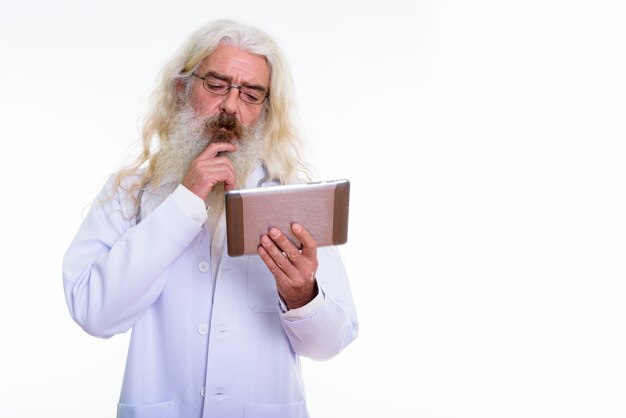 senior bearded man doctor using digital tablet