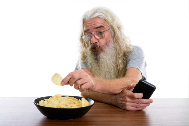 senior bearded man holding mobile phone