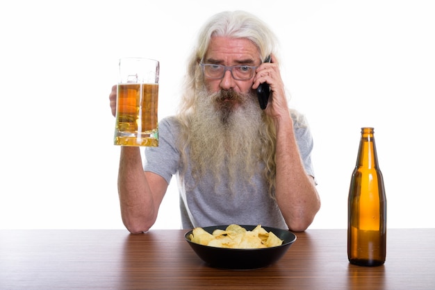 senior bearded man talking on mobile phone