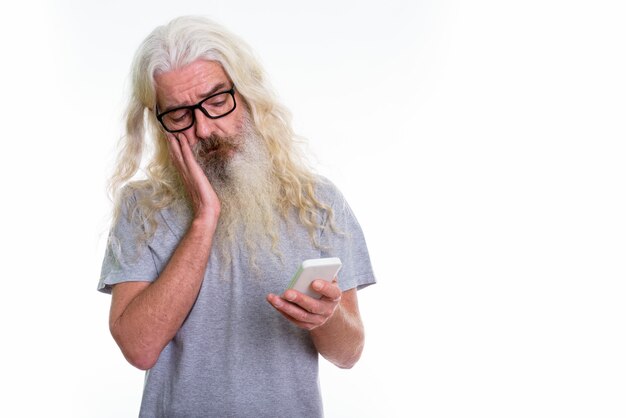 senior bearded man using mobile phone