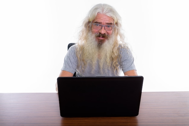 Senior Bearded Man Wearing Eyeglasses While Using Laptop