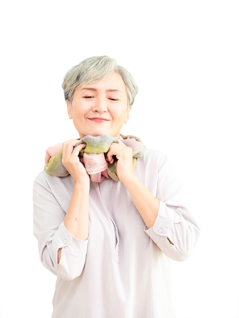 Senior beautiful grey-haired asian woman wearing casual dress and silk scarf