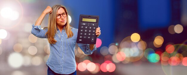 Senior beautiful woman with a calculator