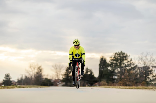 A senior bike rider on a bike in at suburban