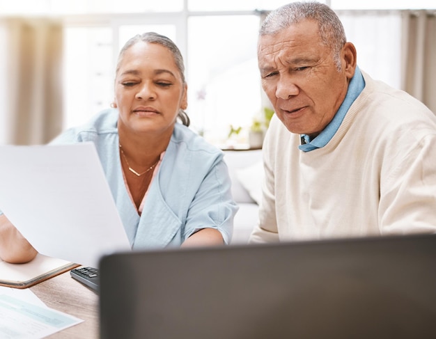 Photo senior black couple documents and laptop for planning budget and taxes with talk for future in home old man woman and reading pc screen for insurance retirement or finance goals with paperwork