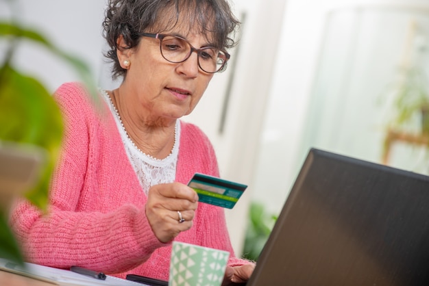 Senior brunette woman shopping with internet