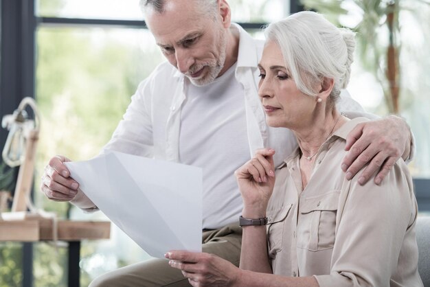 Senior business colleagues converse at office