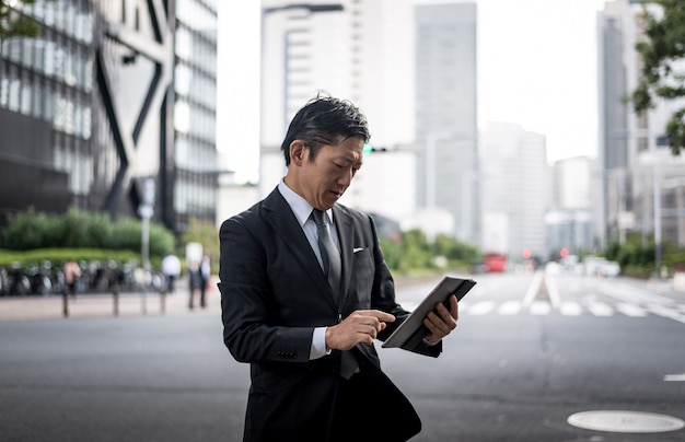 Senior business man moments on the streets of Tokyo