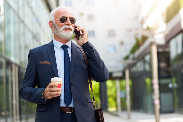 Senior business man talking on phone with client