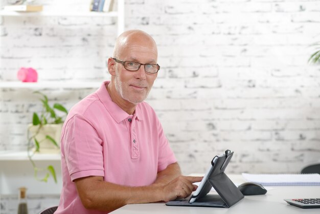 A senior businessman  look a digital tablet