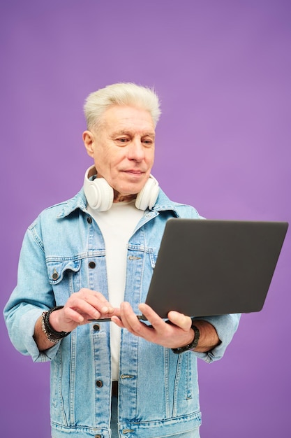 Senior businessman looking at laptop screen during telework