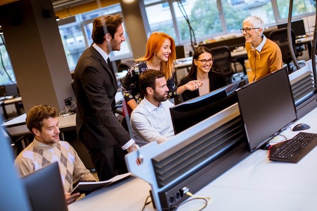 Senior businesswoman and young business people work in a modern office