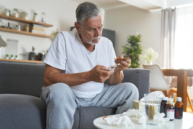 Senior caucasian choosing pills during the flu