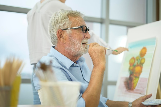 Senior caucasian couple painting and relaxing at home