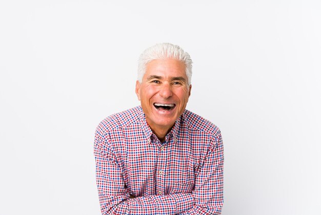 Senior caucasian man isolated laughing and having fun.