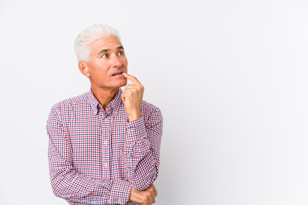 Senior caucasian man isolated looking sideways with doubtful and skeptical expression.