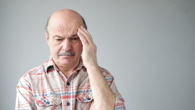 Senior caucasian man showing how much his head hurts experiencing pain