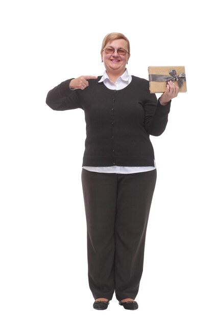 Senior caucasian woman holding gift over isolated background very happy pointing with hand and finger