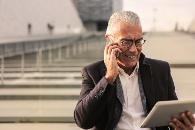 Senior charming businessman talking on a smartphone