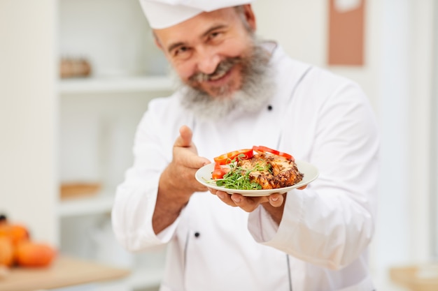 Senior Chef Presenting Steak