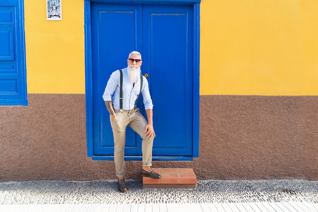 Senior confident man standing on a european streetnear door