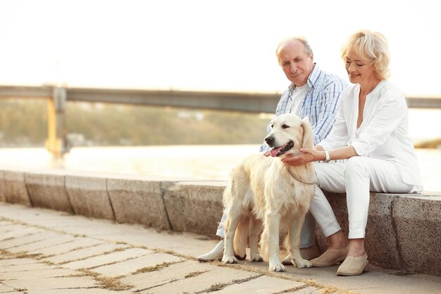 Senior couple and big dog on bund