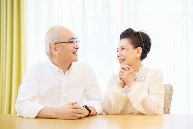 Senior couple chatting with smile in the living room