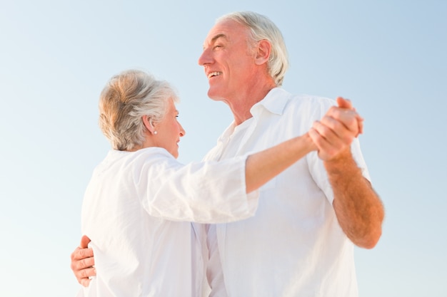 Senior couple dancing on the beach