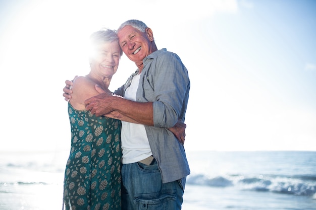 Senior couple embracing at the beach