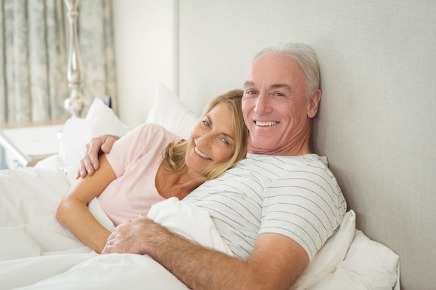 Senior couple embracing on bed